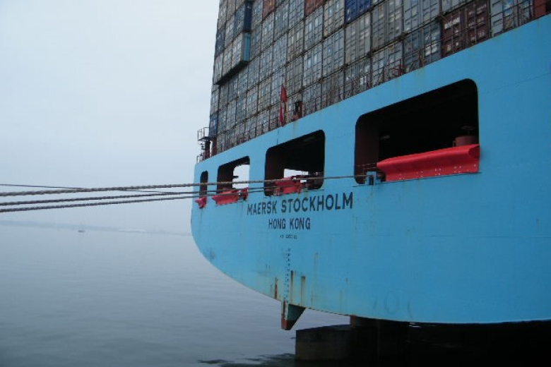 The viewing angle at the rear of the blue coloured ship equipped with anti-piracy barriers, which holds a lot of cargo