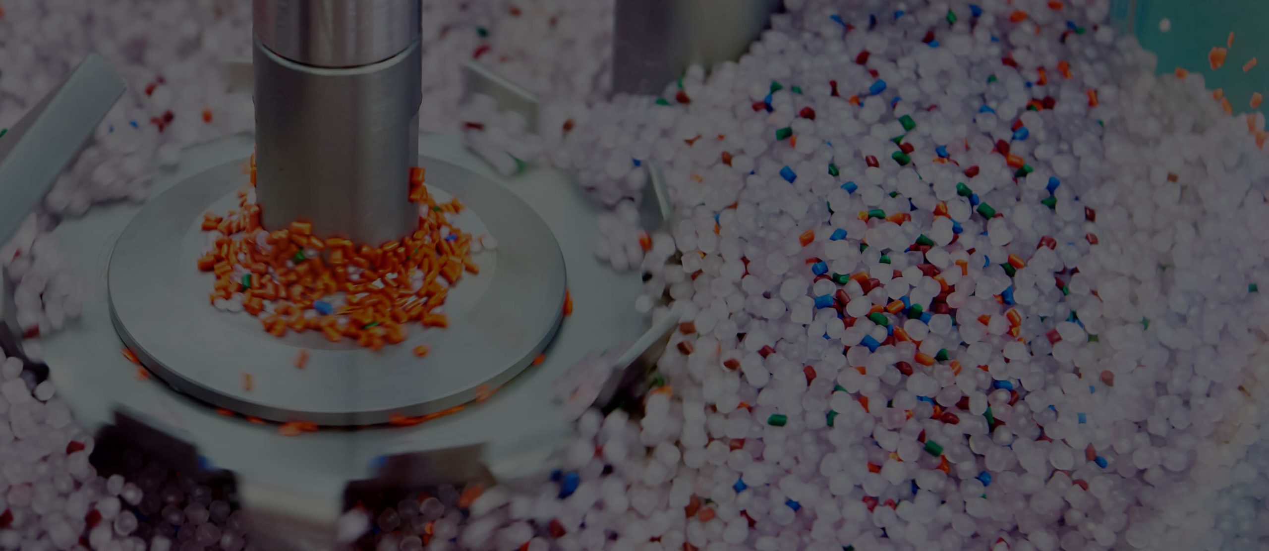 Orange, blue, red, and green coloured masterbatches, along with white masterbatches manufactured by Polymer Link, are being mixed in the machine