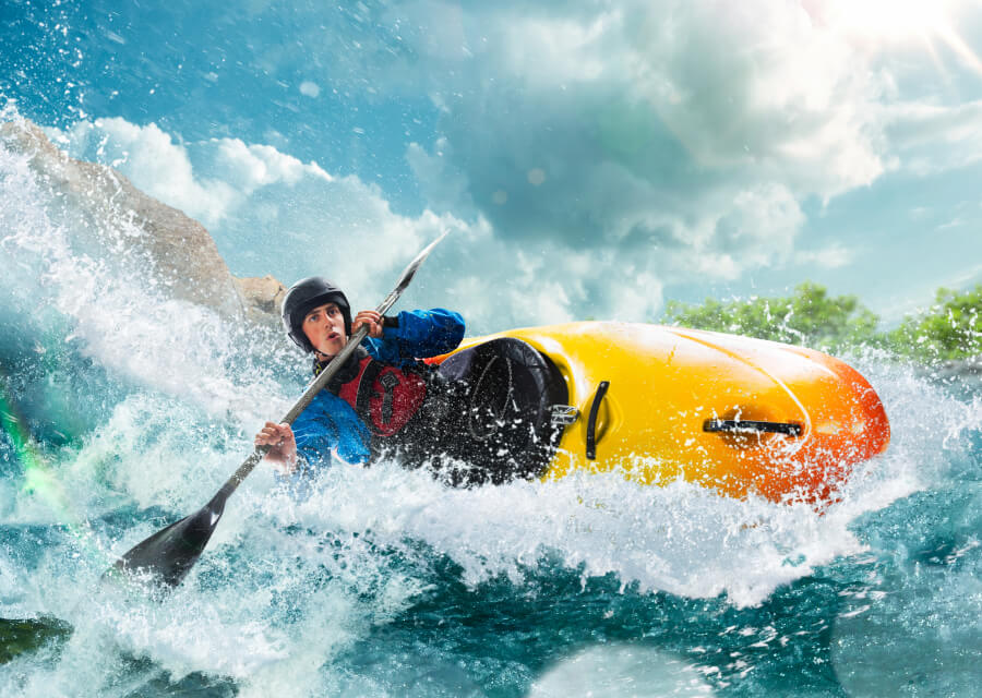 A man kayaking using kayak and double-blade paddle manufactured from Polymer Link's Hyperene Series
