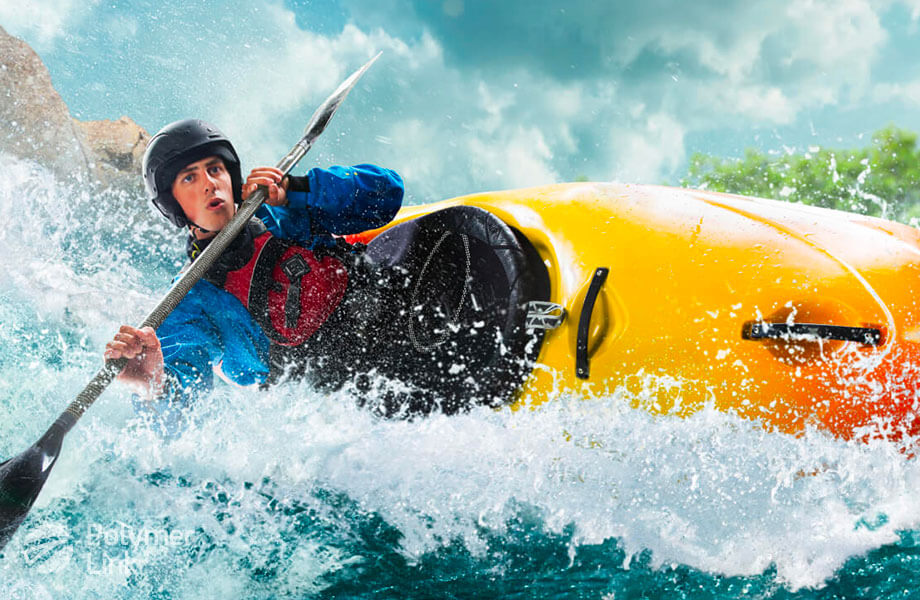 Young man riding on a kayak made with Polymer Link's Hyperene™ Series raw material, which shines the most from its sheer durability and resistance to environmental factors.